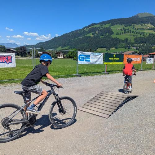 Kinder mit Rad auf Parcours